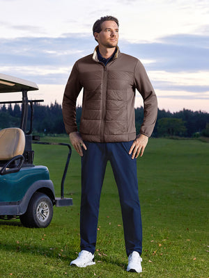 Model posing with hands on hips on course, wearing golf fleece winter puffer jackets in dark brown